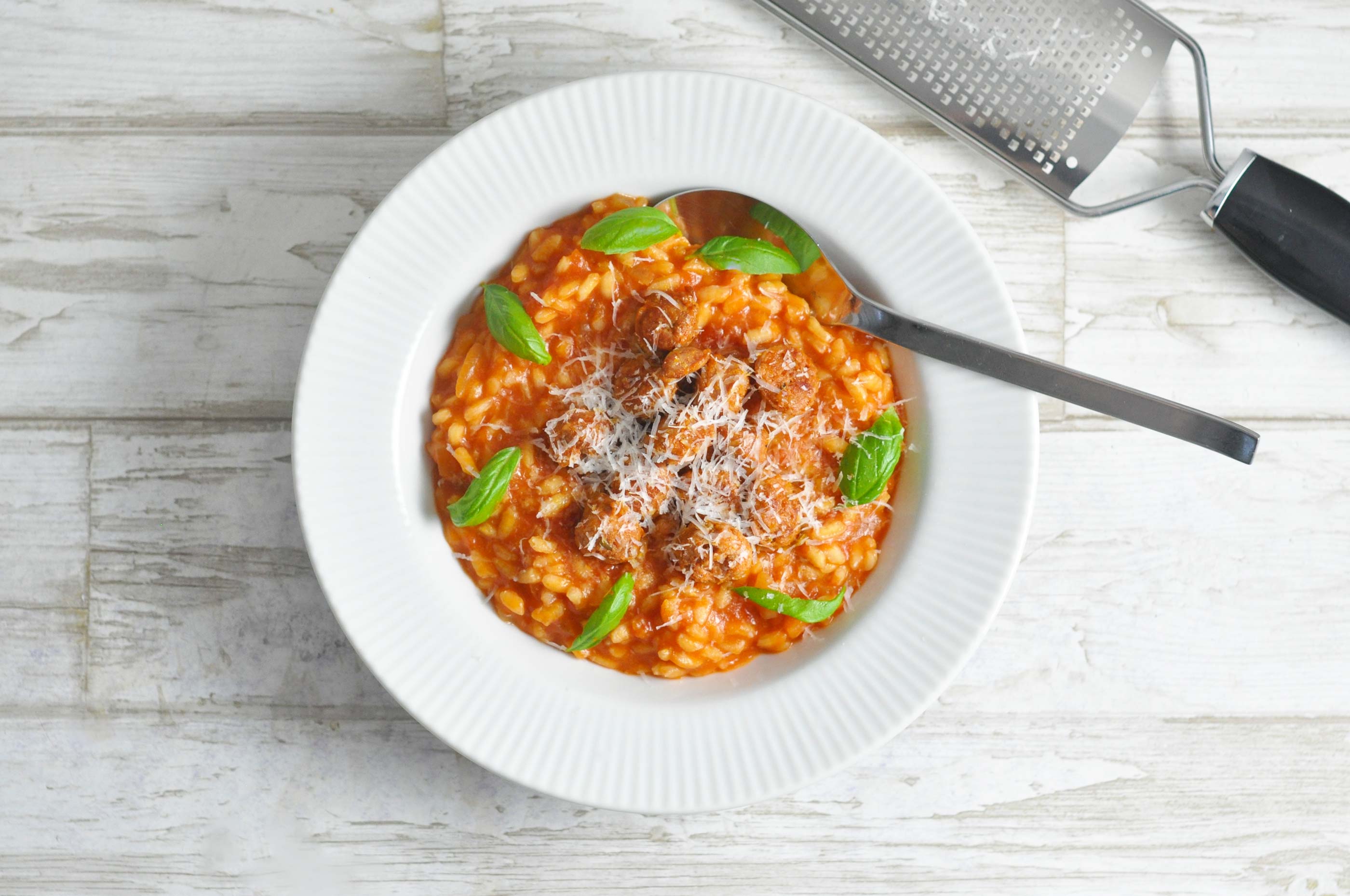 Delicious and creamy tomato risotto topped with crispy chorizo