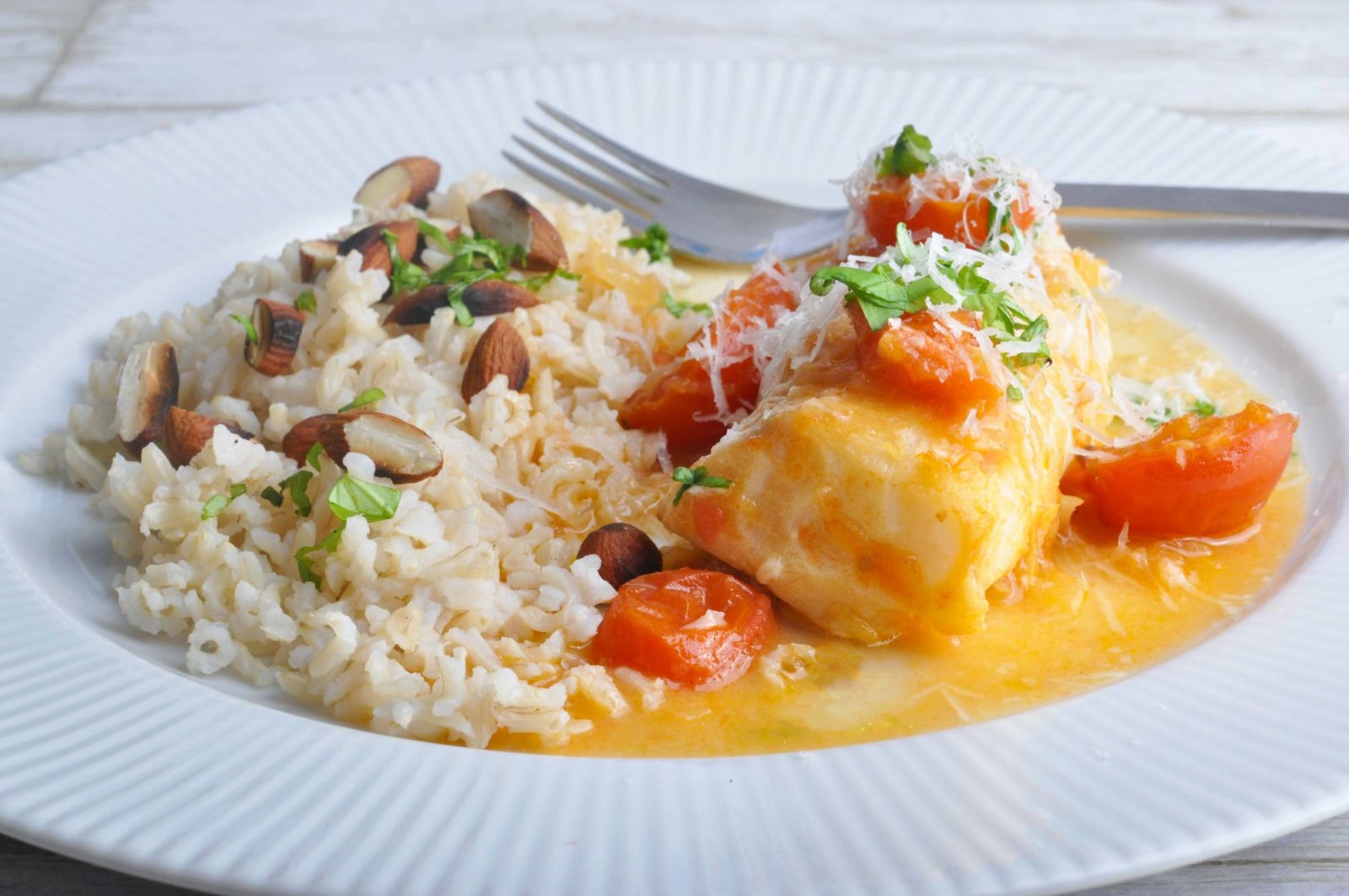 Baked cod in tasty sauce of lemon and cherry tomatoes. Good fish dish