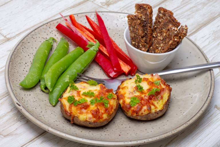 Gratinated baked potatoes with ham filling