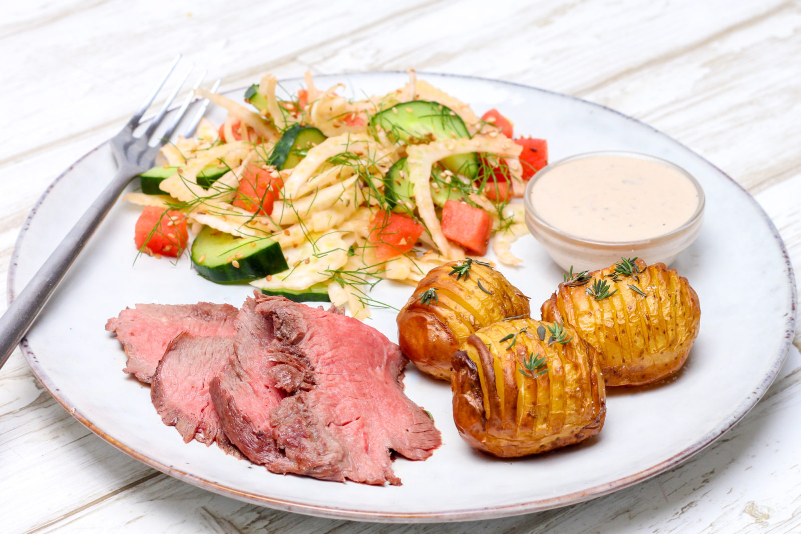 Flat iron steak with hasselback potatoes and fennel salad