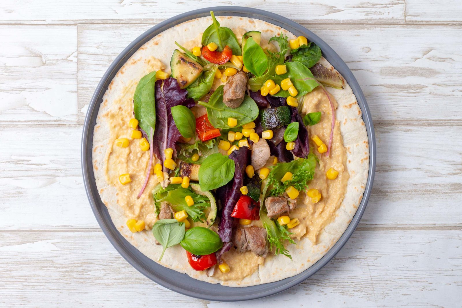 Wraps with tenderloin skewers, salad and hummus