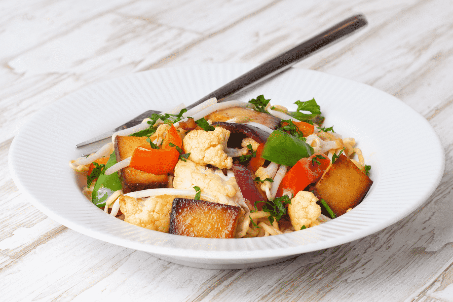 Asian-style fried noodles with tofu and crispy vegetables