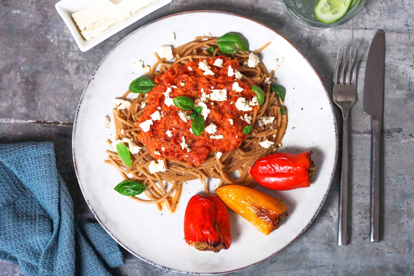 Stuffed bell peppers with chicken mince, pasta and tomato sauce