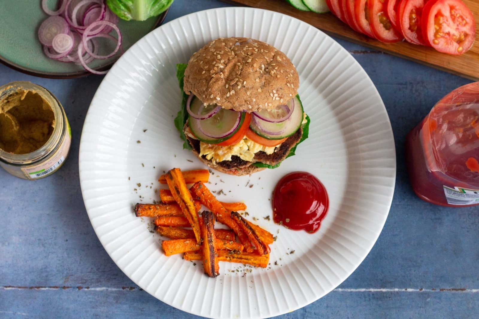 Homemade veggie burgers with breaded celeriac patties and carrot chips