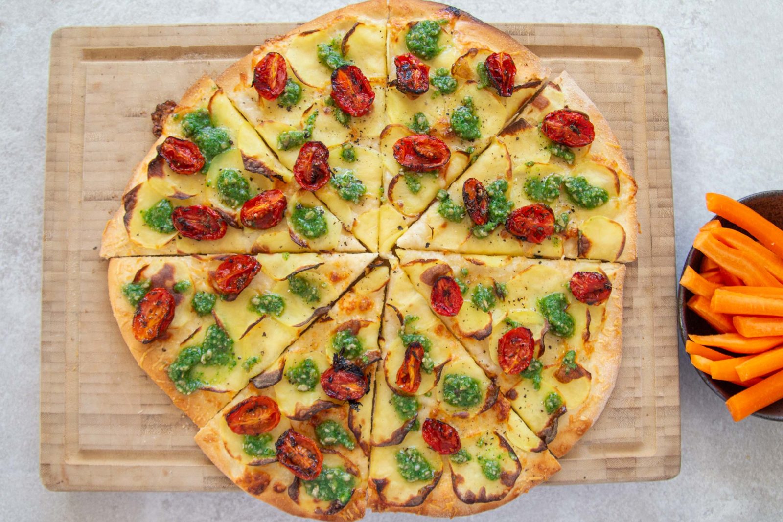 Potato pizza with parmesan, pesto and semidried tomatoes