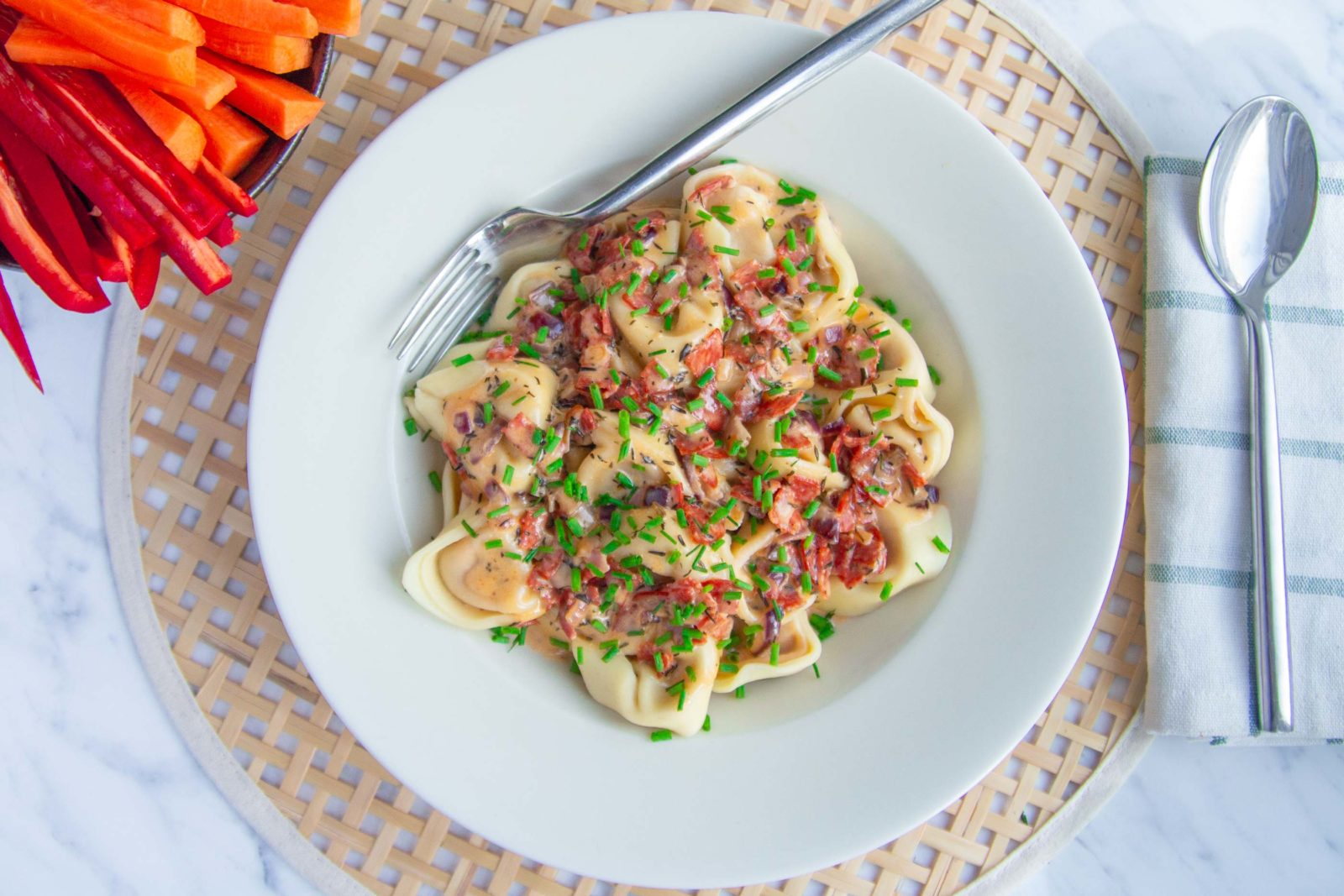 Tortellini in cream cheese sauce with chorizo and snack veg