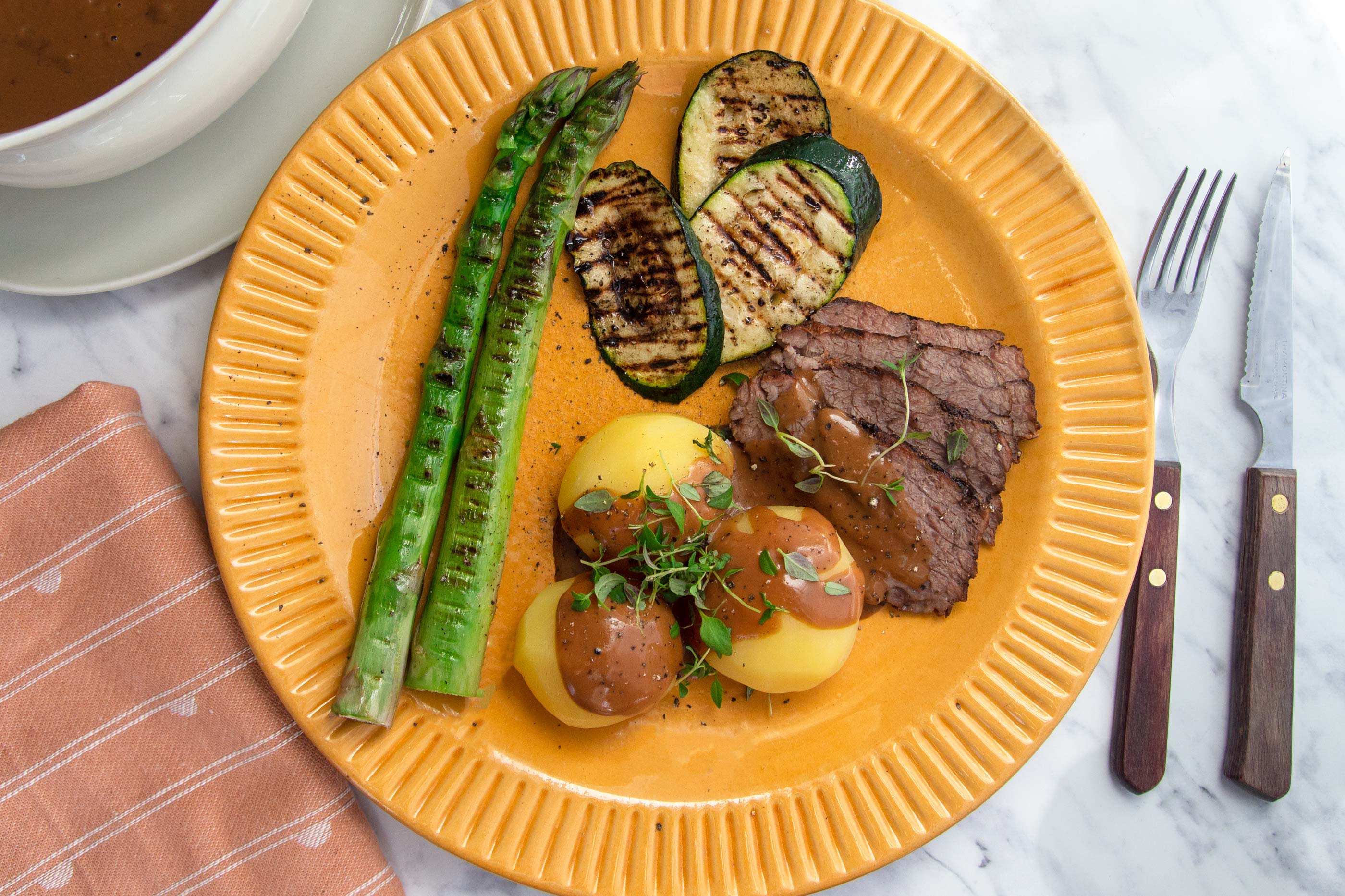 Grilled cuvette with baby potatoes, courgette and