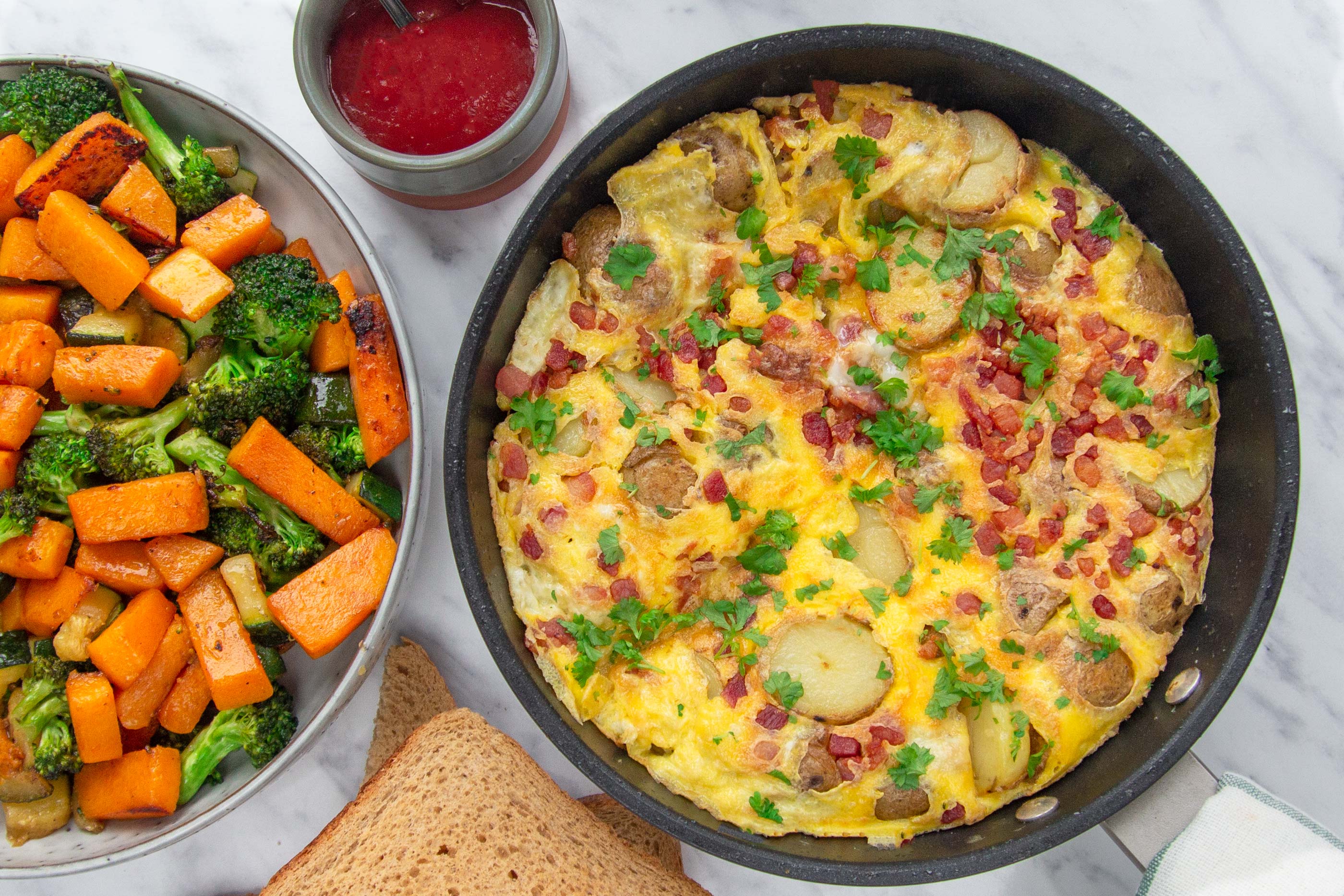 Spanish omelette with bacon, potatoes and pan fried veggies